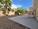 Landscaped backyard featuring a concrete patio, palm trees, and privacy walls perfect for outdoor relaxation at 6638 Babys Tear Pl, Las Vegas, NV 89148