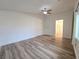 A large bedroom boasts a ceiling fan, hardwood style floors, and a closet at 6638 Babys Tear Pl, Las Vegas, NV 89148
