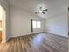 The bedroom is spacious and well-lit with ample natural light, showcasing neutral walls and wood flooring at 6638 Babys Tear Pl, Las Vegas, NV 89148