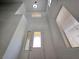 Bright entryway featuring a soaring ceiling, updated lighting and textured white walls at 6638 Babys Tear Pl, Las Vegas, NV 89148
