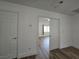 This hall has wood-style flooring and leads to a bedroom, enhancing the home's flow and appeal at 6638 Babys Tear Pl, Las Vegas, NV 89148