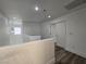 Bright hallway features hardwood floors, neutral paint and staircase to the left, with natural light from a window at 6638 Babys Tear Pl, Las Vegas, NV 89148