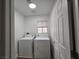 The laundry room includes a washer, a dryer, and a window at 6638 Babys Tear Pl, Las Vegas, NV 89148