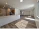 Spacious living room with hardwood floors, recessed lighting, and a large window at 6638 Babys Tear Pl, Las Vegas, NV 89148