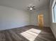 Bright main bedroom features hardwood floors, ceiling fan, and an ensuite bathroom at 6638 Babys Tear Pl, Las Vegas, NV 89148