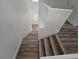 Staircase features wood steps and white walls at 6638 Babys Tear Pl, Las Vegas, NV 89148