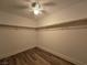 The walk-in closet is equipped with custom shelving and wood-look flooring at 6638 Babys Tear Pl, Las Vegas, NV 89148