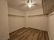 A walk-in closet with ample hanging space, shelving, laminate floors, and ceiling fan at 6638 Babys Tear Pl, Las Vegas, NV 89148