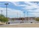 Park's basketball court featuring hoops, lights, and benches at 7224 Anora St, North Las Vegas, NV 89084