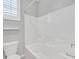 This pristine bathroom features a white tiled shower and a toilet at 7224 Anora St, North Las Vegas, NV 89084