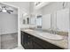Beautiful bathroom featuring double sinks, granite counters, and a view to the bedroom at 7224 Anora St, North Las Vegas, NV 89084
