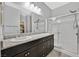 Bathroom featuring double sinks, granite countertops, and a glass-enclosed shower at 7224 Anora St, North Las Vegas, NV 89084