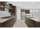 Modern kitchen featuring stainless steel appliances, granite countertops, and a gas cooktop at 7224 Anora St, North Las Vegas, NV 89084