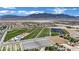 Panoramic aerial shot of the property near agricultural fields and distant mountains, showcasing the serene setting at 7300 Fresh Harvest Ave, Las Vegas, NV 89131