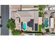 An aerial view shows a home with a pool, a spa, solar panels, and a three-car garage at 7300 Fresh Harvest Ave, Las Vegas, NV 89131