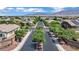 Aerial view showcasing homes in The Orchards with tree-lined streets and mountain views at 7300 Fresh Harvest Ave, Las Vegas, NV 89131