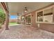 Inviting covered back patio featuring brick flooring, ceiling fans, and sliding glass doors for seamless indoor-outdoor living at 7300 Fresh Harvest Ave, Las Vegas, NV 89131