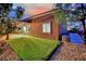 Well-maintained backyard features a lush green lawn, patio area, and mature trees offering shade at 7300 Fresh Harvest Ave, Las Vegas, NV 89131