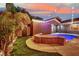 Relaxing backyard featuring a sparkling pool with a stone feature and string lights, perfect for entertaining at 7300 Fresh Harvest Ave, Las Vegas, NV 89131