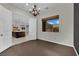 Dining room with dark wood floors and an open view into the kitchen and backyard at 7300 Fresh Harvest Ave, Las Vegas, NV 89131