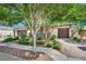 Beautiful single-story home featuring a three-car garage, a stone facade, and manicured landscaping at 7300 Fresh Harvest Ave, Las Vegas, NV 89131