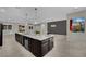 Open kitchen features a large island with granite countertop and stainless steel appliances at 7300 Fresh Harvest Ave, Las Vegas, NV 89131