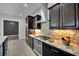 Kitchen features stainless appliances, dark cabinetry, an oven, and a cooktop with a tile backsplash at 7300 Fresh Harvest Ave, Las Vegas, NV 89131