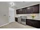 Well-equipped laundry room with front load machines, dark cabinetry and quartz countertop at 7300 Fresh Harvest Ave, Las Vegas, NV 89131