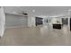 Open-concept living area with tile floor, a decorative wood wall, and access to kitchen area at 7300 Fresh Harvest Ave, Las Vegas, NV 89131