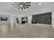Spacious living room with views into the kitchen and front entryway, featuring a dark accent wall at 7300 Fresh Harvest Ave, Las Vegas, NV 89131