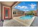 Inviting backyard featuring a cozy pool with a tranquil waterfall feature and outdoor seating area at 7300 Fresh Harvest Ave, Las Vegas, NV 89131