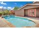 Beautiful backyard pool with a tanning ledge and a waterfall feature at 7300 Fresh Harvest Ave, Las Vegas, NV 89131