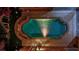 Aerial view of an outdoor backyard pool and spa with string lights and patio at 7300 Fresh Harvest Ave, Las Vegas, NV 89131