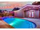 Outdoor pool area with a beautiful, vibrant sunset, highlighting the relaxing backyard at 7300 Fresh Harvest Ave, Las Vegas, NV 89131
