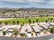 Wide aerial shot showcases the neighborhood with well-kept homes, green spaces and mountain views at 7332 Redhead Dr, North Las Vegas, NV 89084