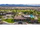 Aerial view of the community clubhouse, pool, tennis courts, and golf course at 7332 Redhead Dr, North Las Vegas, NV 89084