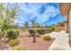 Serene backyard showcases lush landscaping, gravel, and a charming wrought iron fence at 7332 Redhead Dr, North Las Vegas, NV 89084