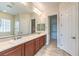 Bright bathroom featuring double vanity, neutral tiling, and separate water closet at 7332 Redhead Dr, North Las Vegas, NV 89084
