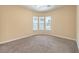 A clean bedroom with plush carpet, neutral walls, and three panel window at 7332 Redhead Dr, North Las Vegas, NV 89084