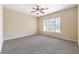Spacious bedroom featuring neutral paint, carpet flooring, ceiling fan and natural light at 7332 Redhead Dr, North Las Vegas, NV 89084