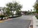 Community entrance gate featuring lush landscaping and covered entry at 7332 Redhead Dr, North Las Vegas, NV 89084