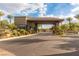 Inviting entrance to the community featuring a covered gatehouse, lush landscaping, and a secure, welcoming entry point at 7332 Redhead Dr, North Las Vegas, NV 89084