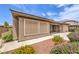 Property exterior featuring low water landscaping, gravel, and manicured shrubs at 7332 Redhead Dr, North Las Vegas, NV 89084