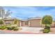 Charming single-story home showcasing manicured landscaping and a spacious driveway leading to a two-car garage at 7332 Redhead Dr, North Las Vegas, NV 89084
