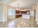 Open kitchen featuring stainless steel appliances, dark wood cabinetry, and tile flooring with an adjacent dining area at 7332 Redhead Dr, North Las Vegas, NV 89084