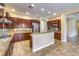 Modern kitchen featuring granite countertops, stainless steel appliances, dark wood cabinetry, and a center island at 7332 Redhead Dr, North Las Vegas, NV 89084