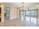 Spacious living area with large windows, tile flooring, chandelier, and open-concept design at 7332 Redhead Dr, North Las Vegas, NV 89084