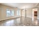 Spacious living area with large windows, tile flooring, chandelier, and views of kitchen and backyard at 7332 Redhead Dr, North Las Vegas, NV 89084