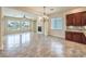 Open living space with tile flooring, large windows, fireplace, and custom cabinetry with granite countertops at 7332 Redhead Dr, North Las Vegas, NV 89084
