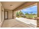 Covered patio with concrete flooring, stone columns, privacy screen and beautiful yard at 7332 Redhead Dr, North Las Vegas, NV 89084